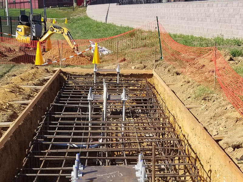 Workers aligning structural columns